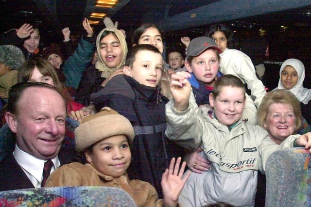 Lottery winners Ray and Barbara Wragg with some of the Park Hill Primary School pupils who were treated to a night out at the pantomime in January 2003