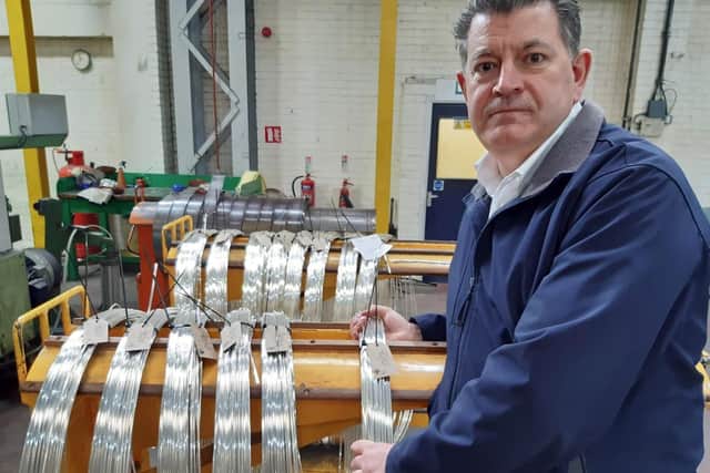 Master Cutler James Tear with silver alloy wire at Thessco in Sheffield.