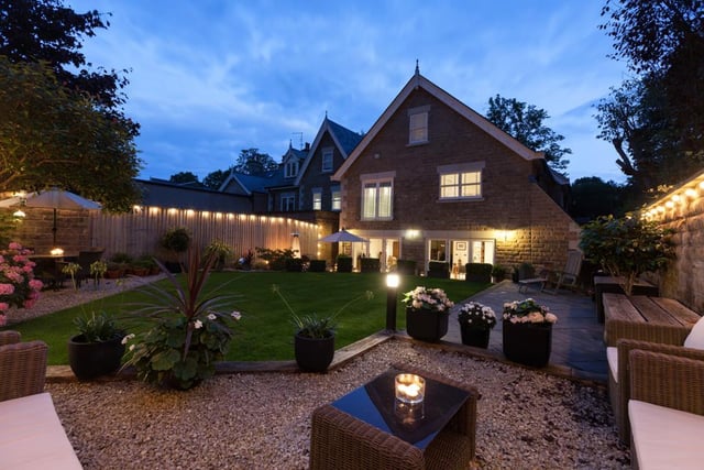 The rear garden has a stone flagged seating terrace with exterior lighting, mature trees and a 'sphere' water feature.