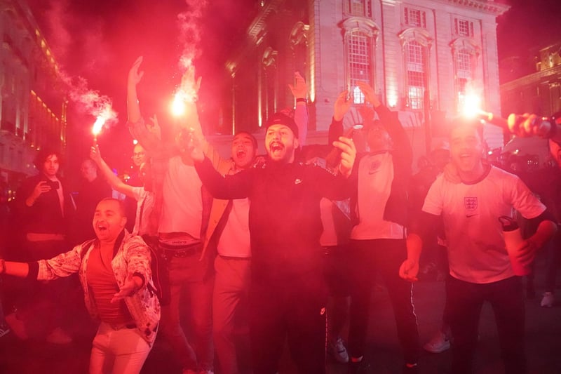 Fans let of flares as they celebrate in Piccadilly Circus, central London after England qualified for the Euro 2020 final.