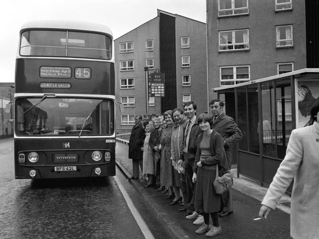 Passengers at the bus stop as the 45 bus draws up at Dumbiedykes housing scheme in Edinburgh, June 1980.