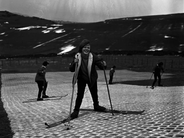 A schoolgirl enjoying her time at Hillend, with the Pentland Hills in the background, in December 1965.
