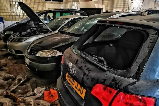 Smashed up cars inside a warehouse in Darnall, Sheffield