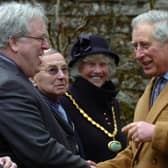 King Charles III meeting and greeting local dignitaries.