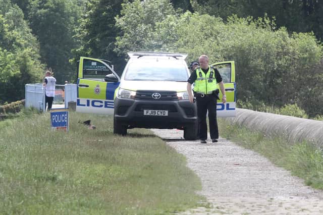 Police on Dam wall at Toddbrook Reservoir