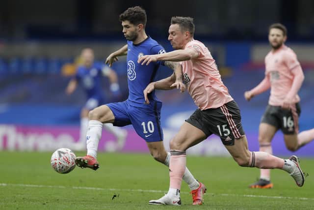 Chelsea's Christian Pulisic, left, is challenged by Sheffield United's Phil Jagielka  (AP Photo/Kirsty Wigglesworth)