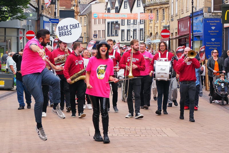 Members of Back Chat Brass walk through the streets of Mansfield.