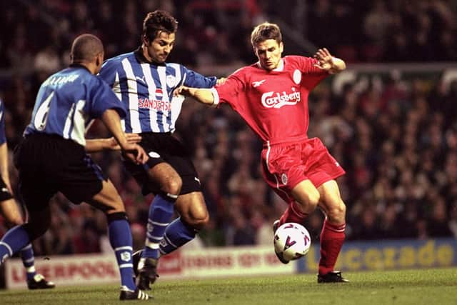 5 Dec 1999:  Michael Owen of Liverpool is tackled by Emerson Thome of Sheffield Wednesday during the FA Carling Premiership match played at Anfield. Liverpool won the game 4-1. Credit: Michael Steele