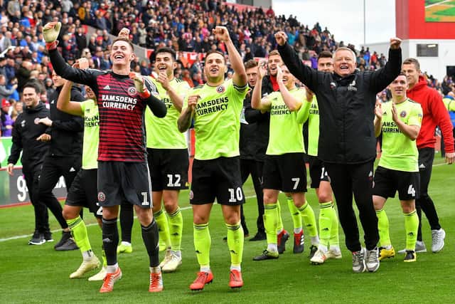 Sheffield United manager Chris Wilder (right), Billy Sharp (centre) and goalkeeper Dean Henderson (left) celebrates promotion to the Premier League after the Sky Bet Championship match at the bet365 Stadium, Stoke