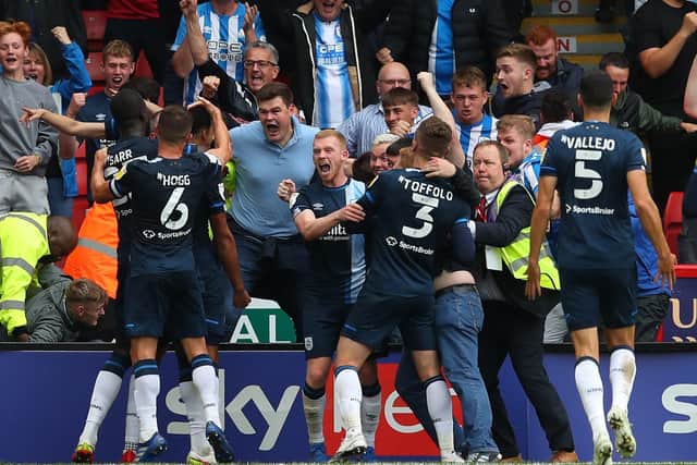 Levi Colwill of Huddersfield Town is mobbed after scoring the winning goal: Simon Bellis / Sportimage