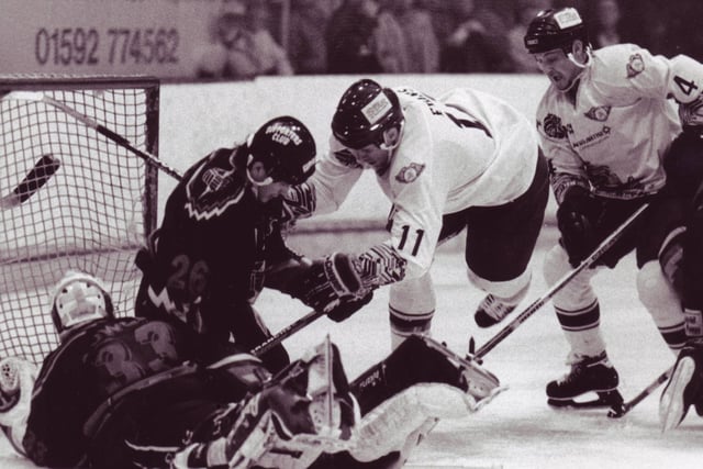 Frank Evans was a good pick up from Knoxville Cherokees in the ECHL for the tail end of the 1995-96 season. He added some toughness to the blue line - 9 games, 54 PIMs! He is pictured challenging Sheffield Steelers netminder  Wayne Cowley and defenceman Ron Schudra (Pic: John Hutton)