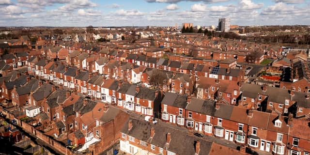 An aerial panorama view of rows of red brick back to back terraced housing in a Northern city in England