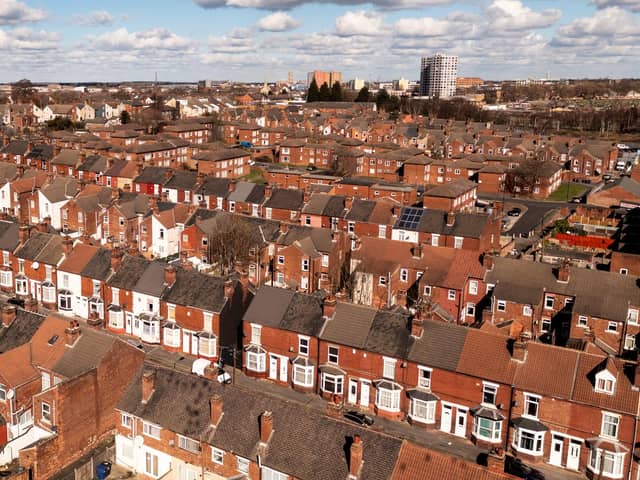 An aerial panorama view of rows of red brick back to back terraced housing in a Northern city in England