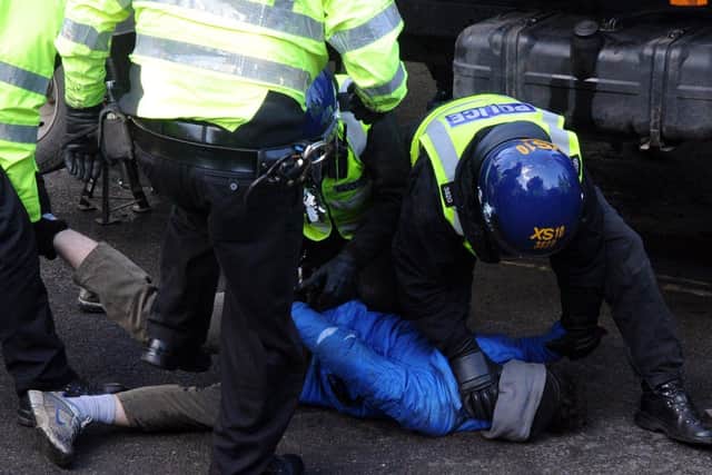 8 March 2018....... Tree protests on Kenwood Road in the Nether Edge area of Sheffield. A protester is forcefully removed from under a contractor's truck after stopping felling from taking place. Picture Scott Merrylees