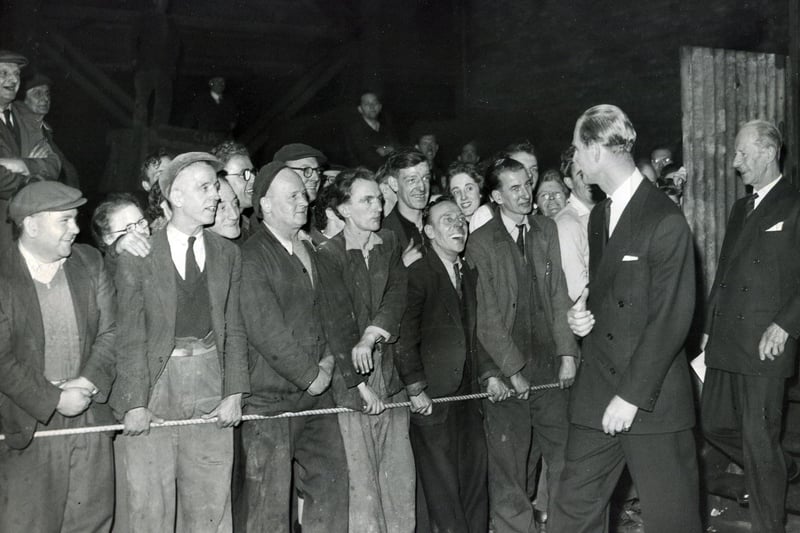 Workers in the Heavy Forge give the Duke of Edinburgh a cheer after he leaves the controls of the giant press during his tour of Hadfield's on October 24,  1957