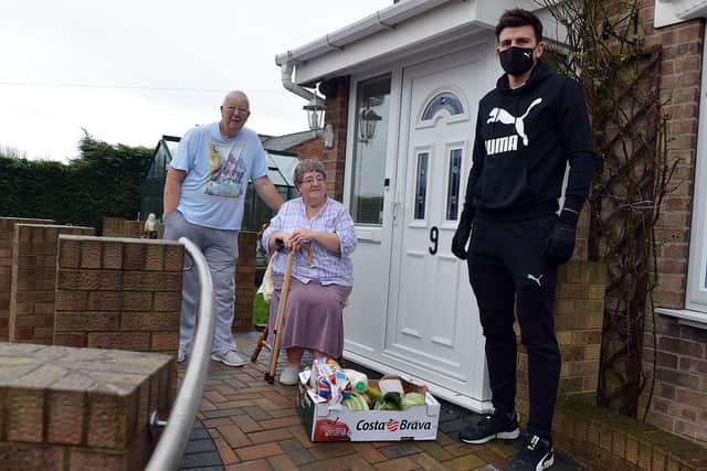 Footballer Harry Maguire hands out food parcels in Mosborough. Seen with residents Alan and Brenda Burton.