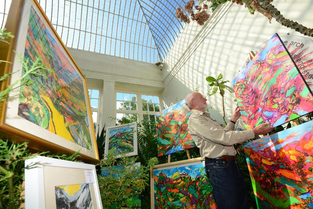 Artist David Brightmore with some of his paintings in one of the glasshouses in the Botanical Gardens for Art in the Gardens in September 2015. Art in the Gardens is one of the popular annual events that brings thousands of visitors to the venue to see a wide range of exhibitors
