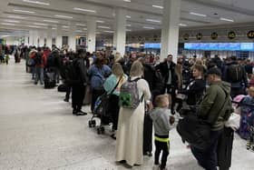 Passengers queue inside the departures area of Terminal 1 at Manchester Airport, as the Easter getaway starts (pic: Peter Byrne/PA Wire)