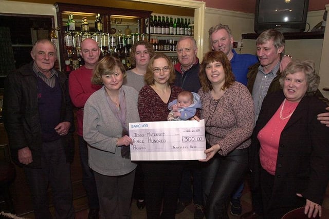 Pictured at the Travellers Rest Pub, Langsett Road South, Oughtibridge, Sheffield, where £300 raised by carol singing over the Christmas period was presented to the Jessop's Neonatal Unit, January 2003
