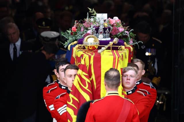 The coffin is carried out of Westminster Abbey during the state funeral and burial of Queen Elizabeth II at Westminster Abbey on September 19, 2022 in London, England  (Photo by Hannah McKay - WPA Pool/Getty Images)