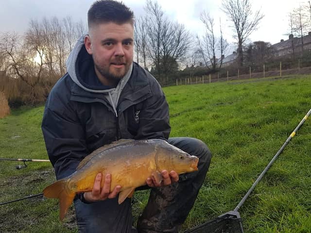 Angler Tom Middleton with the Mirror Carp he caught in Arourthorne Pond