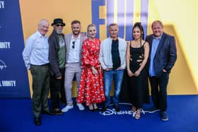 The cast of The Full Monty re-unite in Sheffield for the premiere of the new Disney+ TV version of the film. Pictured are Steve Huison (Lomper), Paul Barber (Horse), Wim Snape (Nathan), Lesley Sharp (Jean), Robert Carlyle (Gaz), newcomer Talitha Wing, who plays Gaz's daughter Destiny, and Mark Addy (Dave)