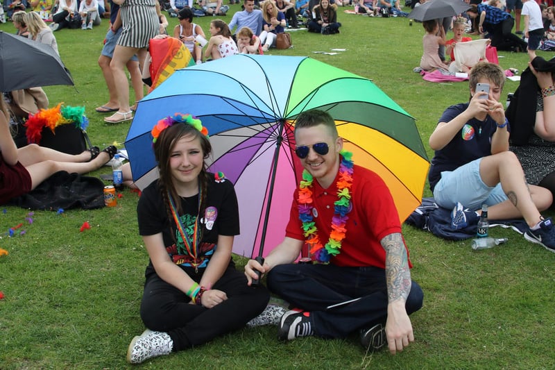 Sheltering from the showers are Bethany Wain and Iain McDonald - Gay pride Chesterfield.