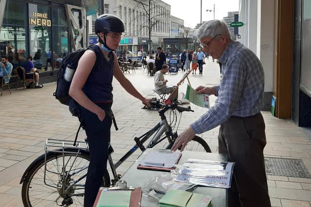 South Yorkshire Better Buses campaigner George Arthur talking to a passer-by at a campaign stall on The Moor in Sheffield, Thursday March 24, 2022