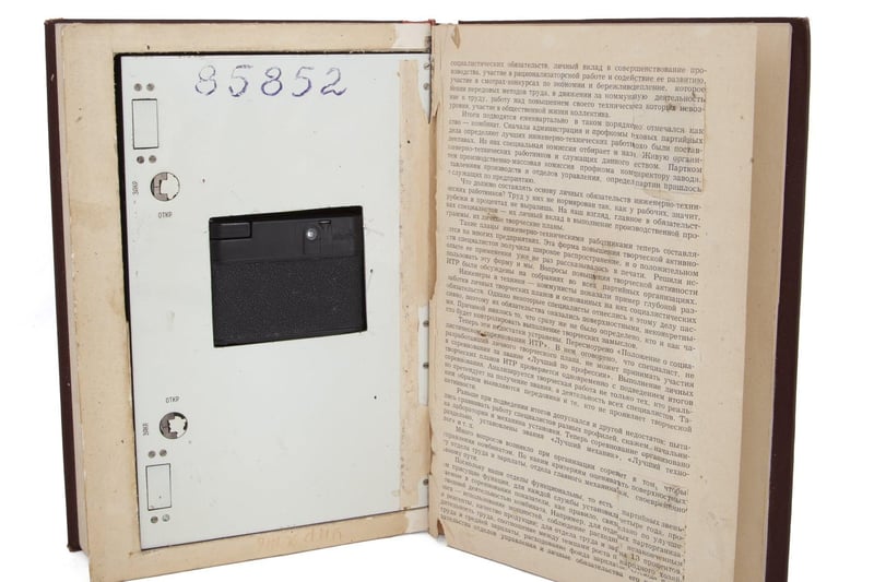 A Soviet KGB spy book containing a hidden "Neozit" camera, with the lens operating through a small moveable section on the front of the book. 9 3/4 by 6 5/8 by 2 inches Estimate: $2,000 - $3,000.