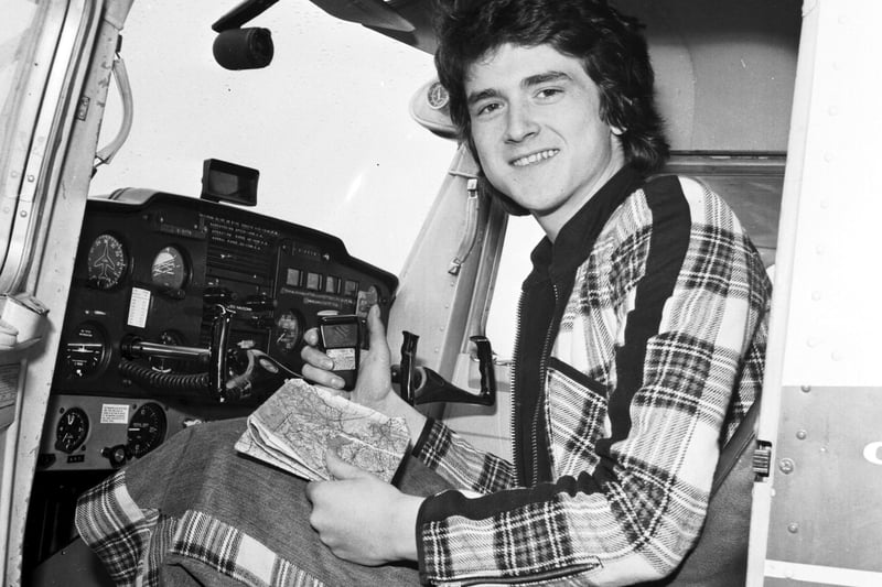 Les McKeown of the Bay City Rollers takes flying lessons at Turnhouse airport, Scotland in April 1975