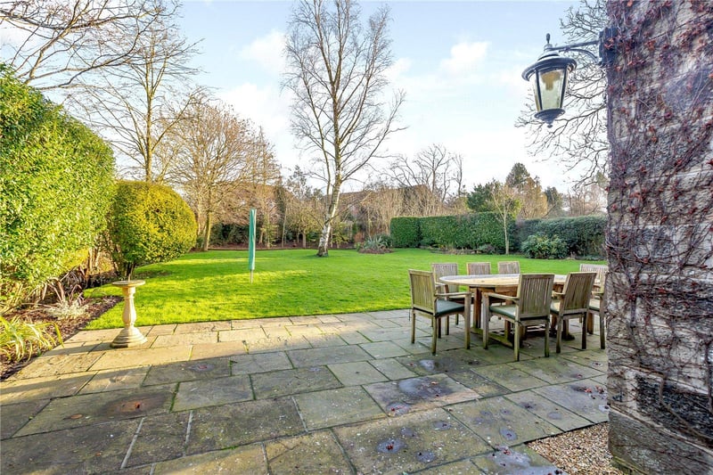 The garden to the side and rear of the property includes paved terracing, lawns, border flowerbeds, shrubs and hedgerows, as well as a number of mature trees.