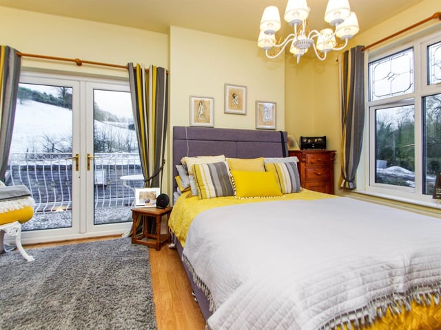 UPVC window to front overlooking the garden, UPVC French doors leading to the balcony.