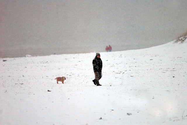 It was cold enough to snow on the sands in 2009, as this dog walker found out.