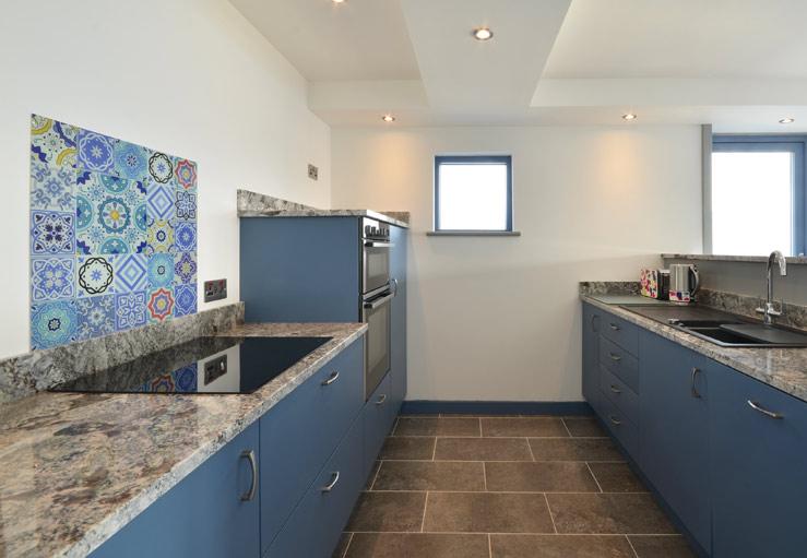 The kitchen is well-equipped and stylish.
