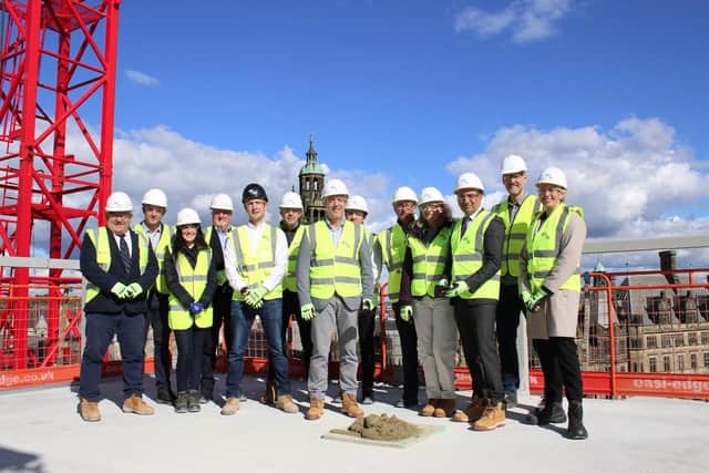 Builders celebrate hotel 'topping out'.