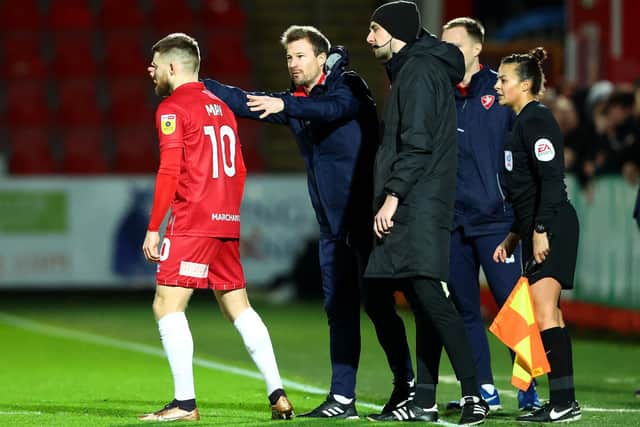 Wade Elliott, manager of Cheltenham, speaks with Alfie May during the Papa John's Trophy quarter final match between Cheltenham Town and Salford City at Completely-Suzuki Stadium on January 10, 2023 in Cheltenham, England. (Photo by Dan Istitene/Getty Images)