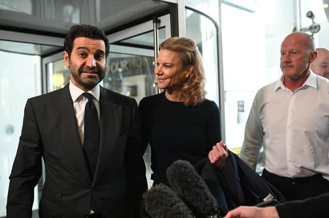 Newcastle United's new director Amanda Staveley (C) and husband Mehrdad Ghodoussi (L) talk to the media as she leaves the foyer of St James' Park in Newcastle upon Tyne in northeast England on October 8, 2021, after the sale of the football club to a Saudi-led consortium was confirmed the previous day. - A Saudi-led consortium completed its takeover of Premier League club Newcastle United on October 7 despite warnings from Amnesty International that the deal represented "sportswashing" of the Gulf kingdom's human rights record.  (Photo by OLI SCARFF/AFP via Getty Images)
