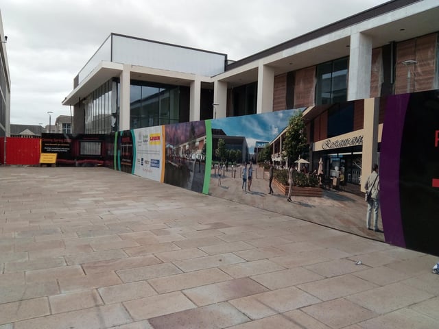 The boards in front of the cinema site on Waterdale show how the building behind them is taking shape