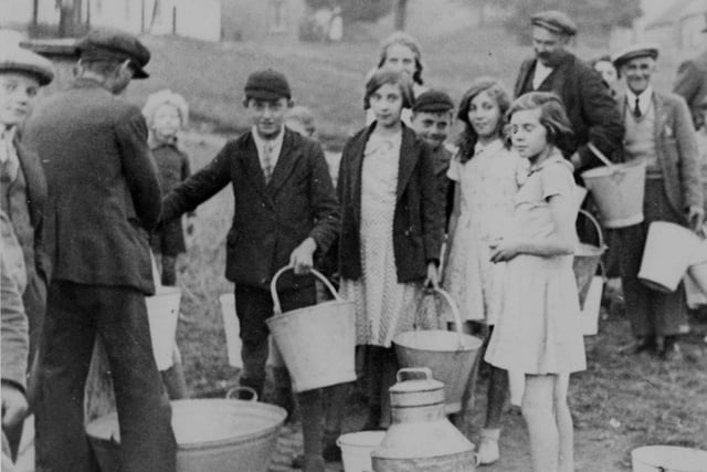 An undated photo showing a group of  people with buckets and pails to collect water from a stand-pipe on the Elwick village green. Photo: Hartlepool Museum Service.