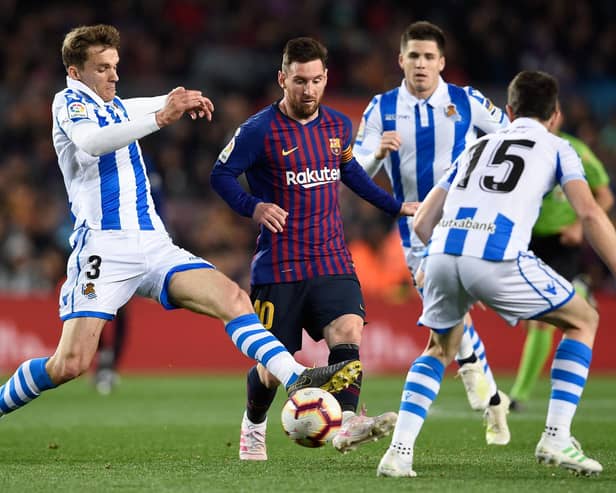 Barcelona's Argentinian forward Lionel Messi (C) is tackled by Real Sociedad's Spanish defender Diego Llorente (L) during the Spanish league football match between FC Barcelona and Real Sociedad at the Camp Nou stadium in Barcelona: PAU BARRENA/AFP via Getty Images)