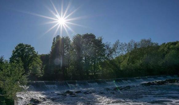 The sun high in the sky over Sprotbrough Falls from @distorted.vision_