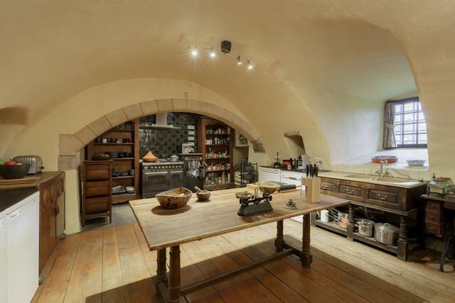 The kitchen has a historic vaulted ceiling as well as modern additions such as a Britannia gas range cooker and a double sink and a larder.
