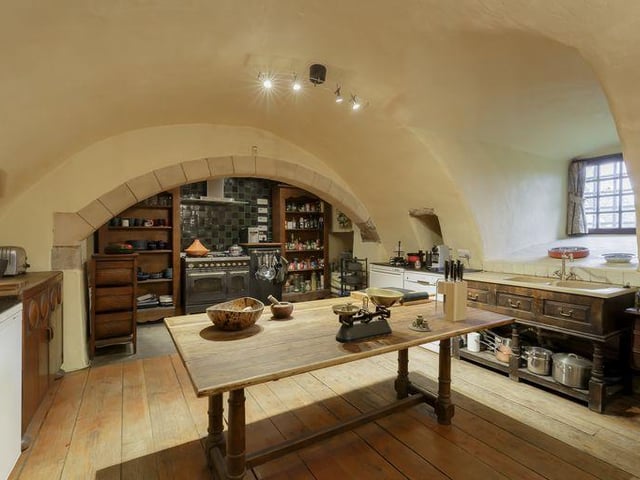 The kitchen has a historic vaulted ceiling as well as modern additions such as a Britannia gas range cooker and a double sink and a larder.