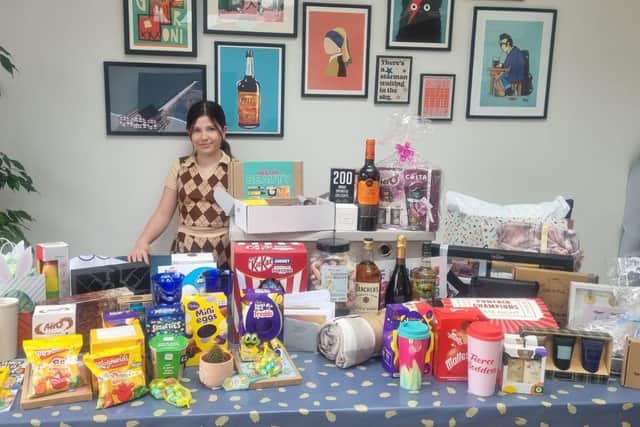 Lauren Marks with her table of prizes she brought in by asking Sheffield businesses for support her charity raffle. With their help, she raised £2,270 for the Ukraine appeal.