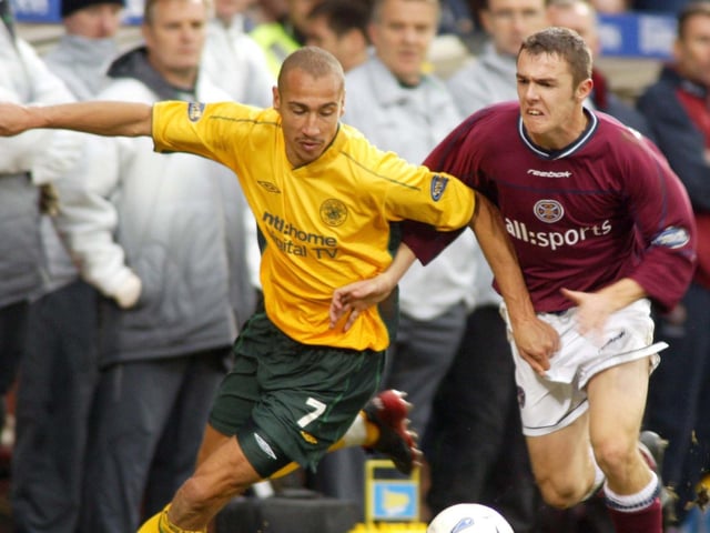 Who is this battling Henrik Larsson for possession?