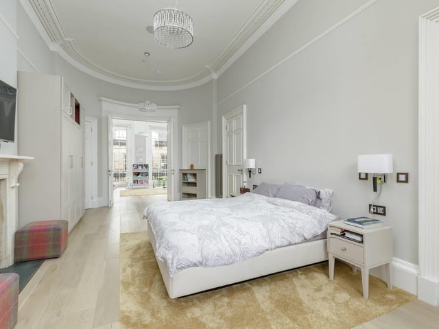 There are seven bedrooms in this property. Some are currently being used as bedrooms, while others have been converted into offices. This bedroom benefits from its own entrance to the garden and a smart en-suite shower room.