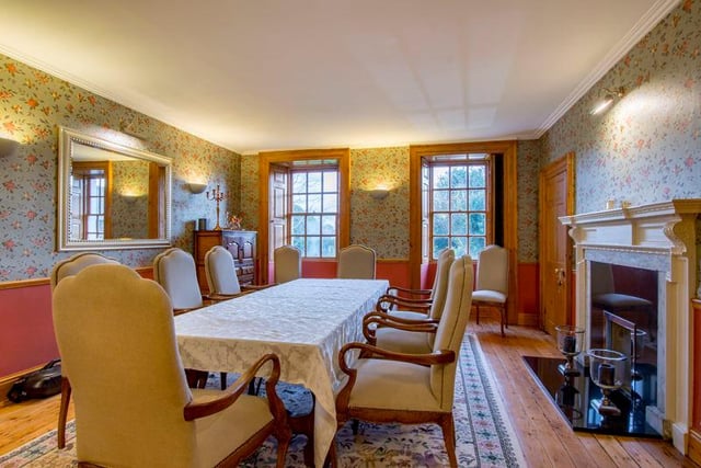 A traditional dining room with a feature fireplace.