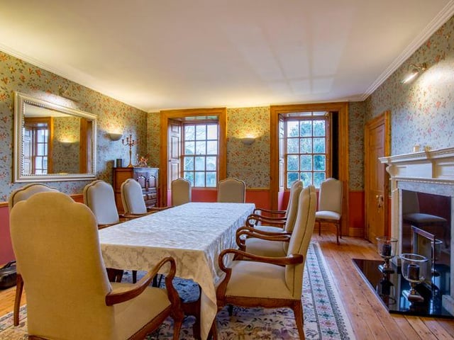 A traditional dining room with a feature fireplace.
