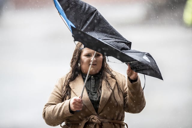 A fan arrives in the heavy rain for the Premier League match at Bramall Lane between Sheffield United and AFC Bournemouth as Storm Ciara hit the UK on Sunday, February 9, 2020