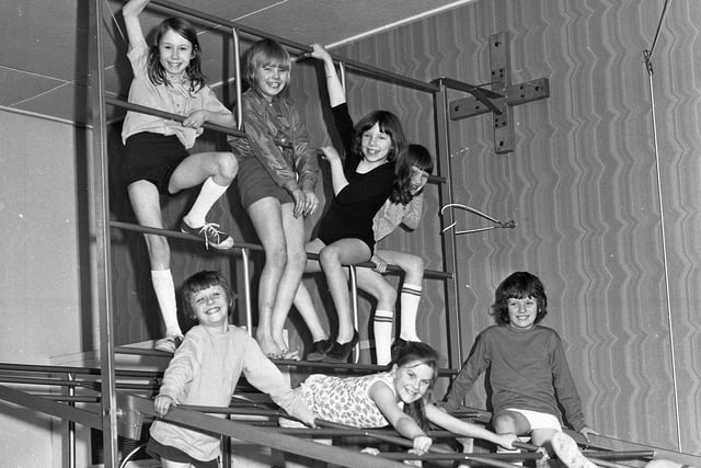Pupils at Red House Junior School playing on climbing apparatus in 1974. Remember doing this?